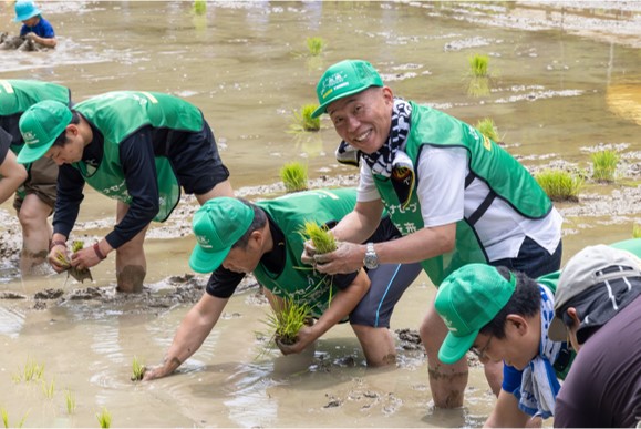 泥だらけになりながら田植え